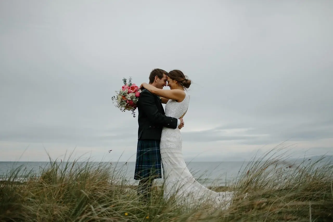 Bride and groom kissing at the end of their wedding ceremony
