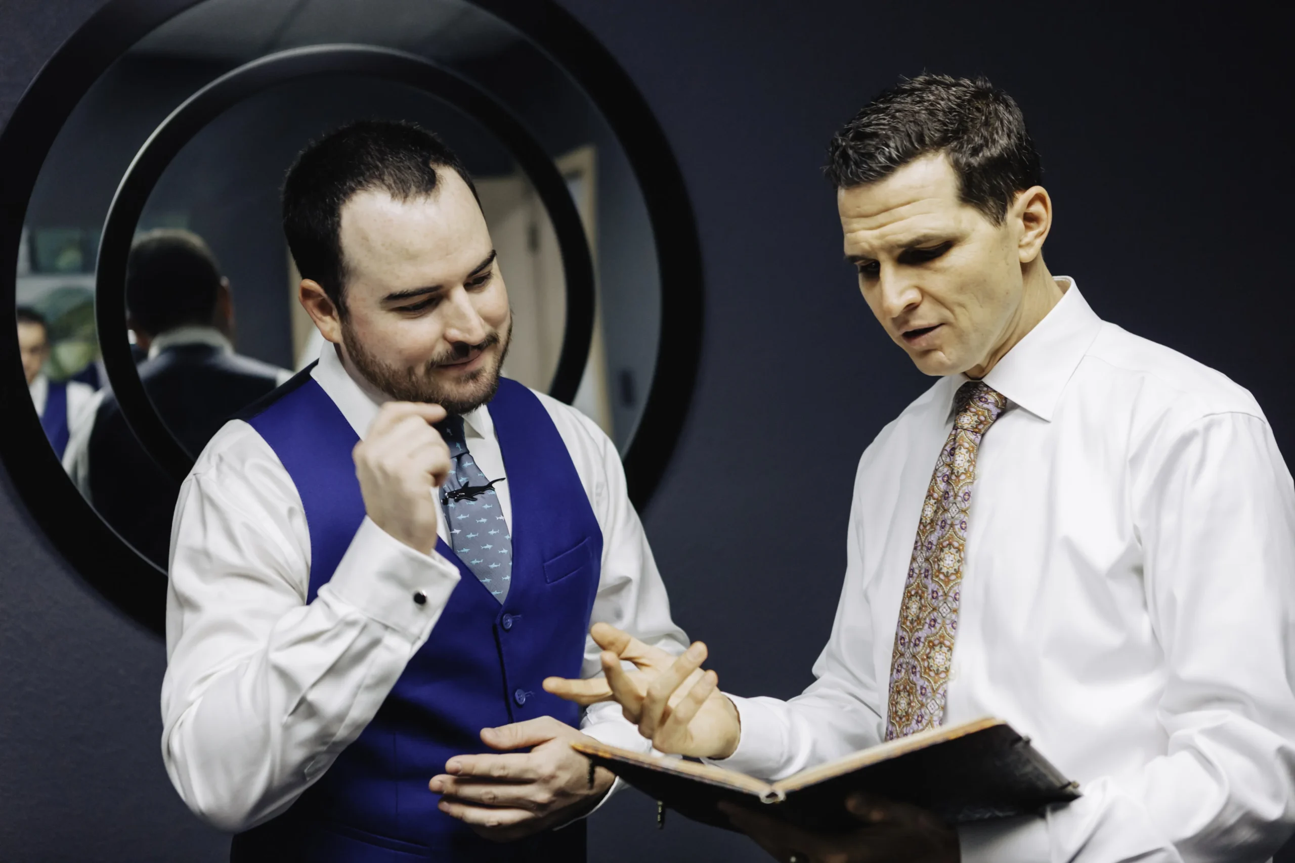 Officiant Matt Nathanson going over vows with the groom before the ceremony