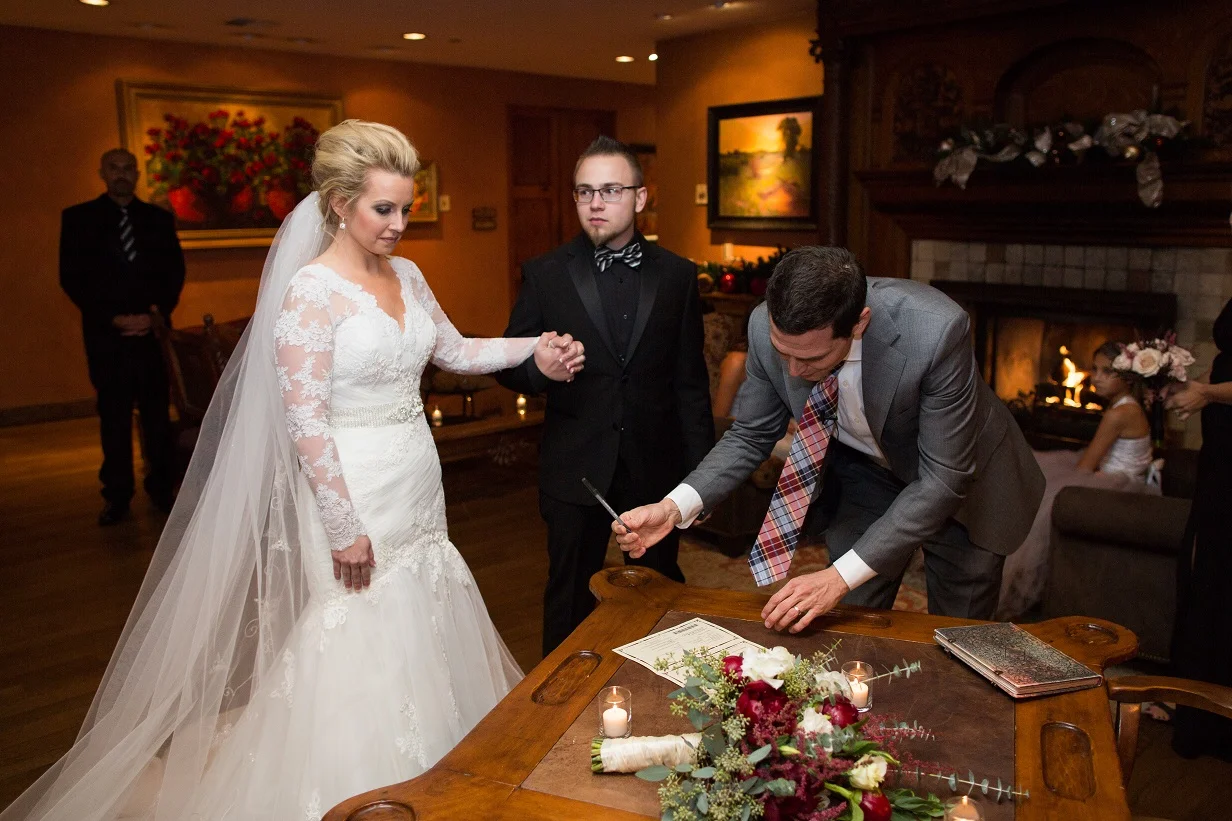 Signing the marriage license with the bride and groom