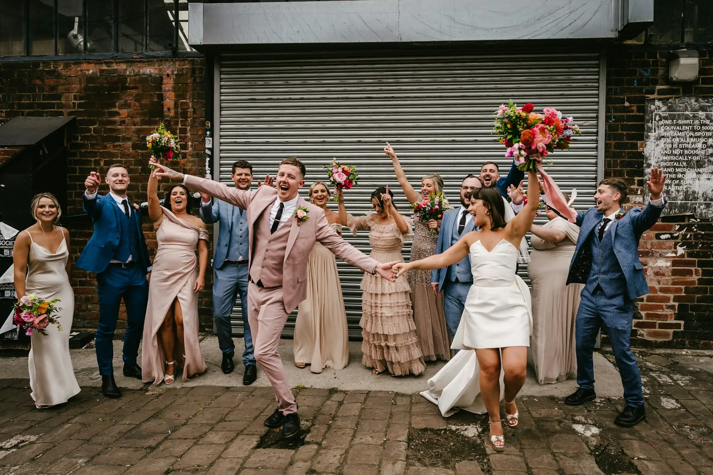 Bridal party jumping and celebrating after a wedding ceremony